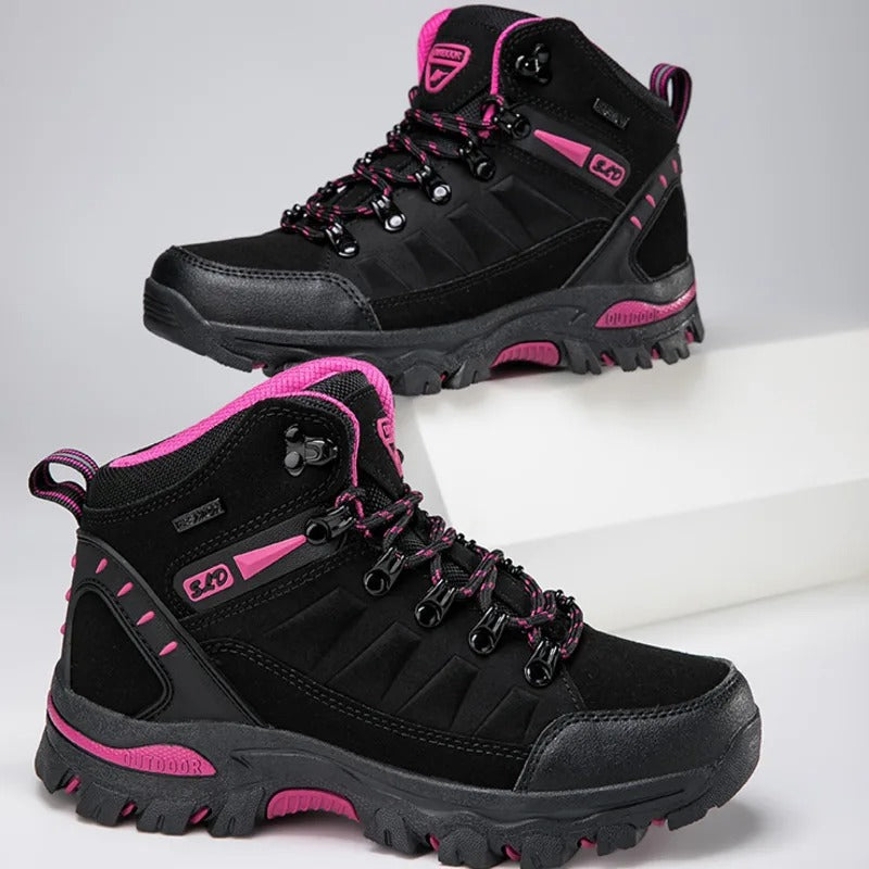 Black outdoor boots with pink accents angled view