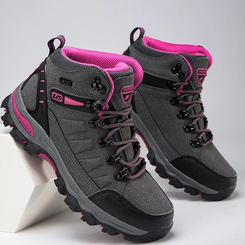 Gray outdoor boots with pink accents angled view