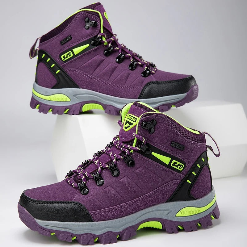 Purple outdoor boots with green accents angled view