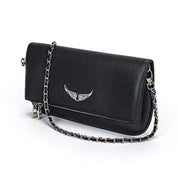 Black leather clutch with silver chain and wing embellishment, angled view