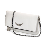 White leather clutch with silver chain and wing embellishment, angled view